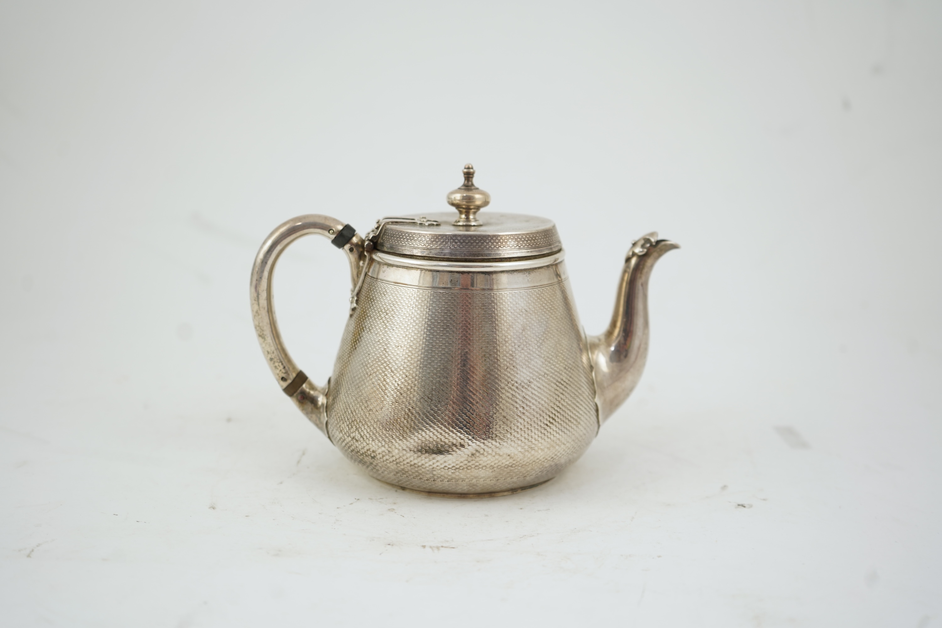 A Victorian engine turned silver teapot by Hunt & Roskell